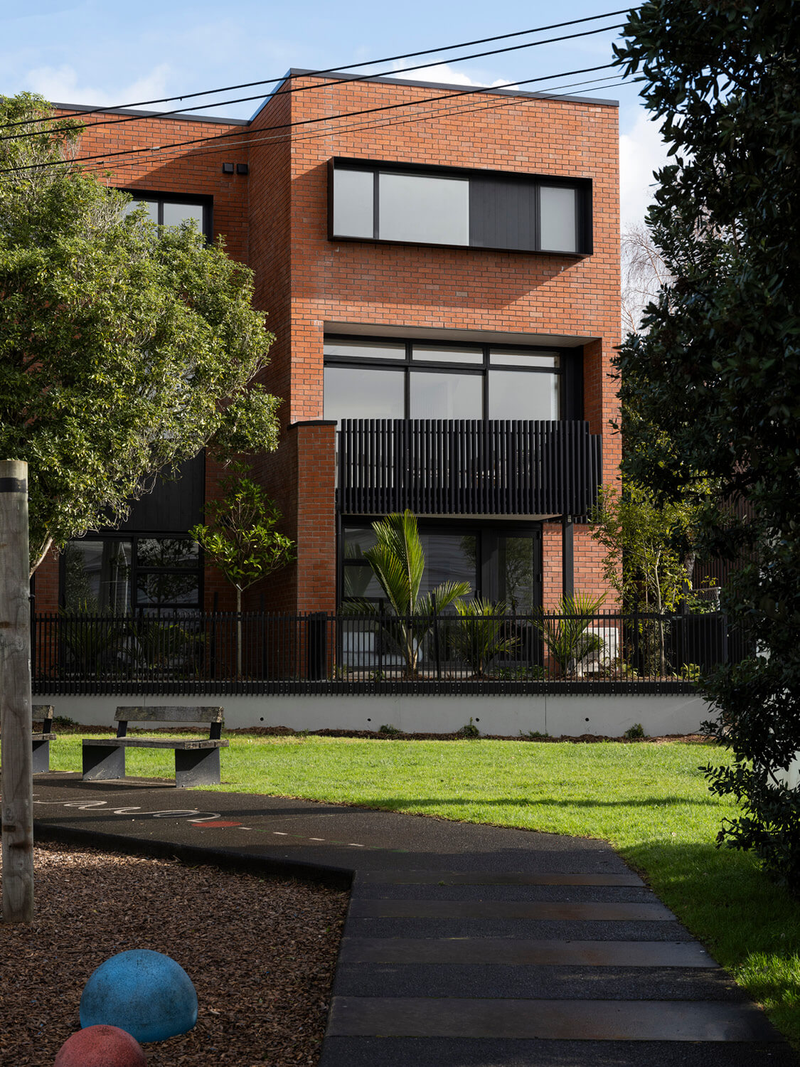 Mesa Morningside Auckland city multi-unit terrace developments crafted in clay brick and black metal side view